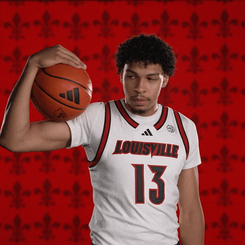 Man in Louisville Jersey Holding Basketball