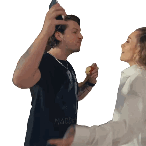 Man in Madden Shirt Holding Woman's Arm