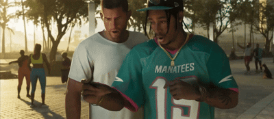 Man in Manatees Jersey Looking at Cell Phone