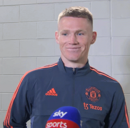Man in Manchester United Jacket Smiling