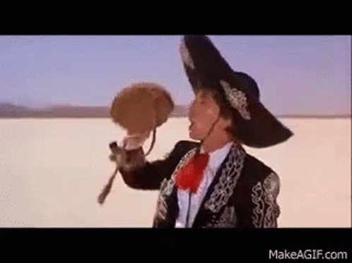 Man in Mariachi Outfit Holding Fan