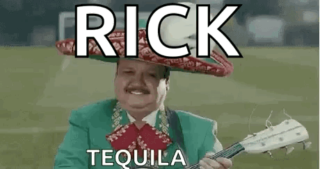 Man in Mariachi Outfit Holding Guitar