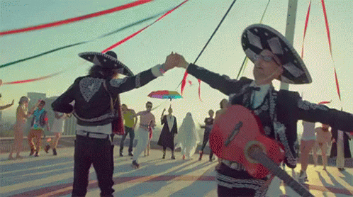 Man in Mariachi Outfit Holding Hand Guitar