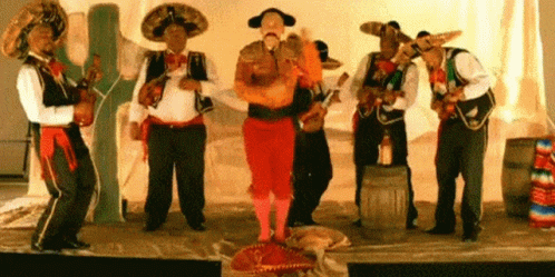 Man in Mariachi Outfit Holding Orange Guitar