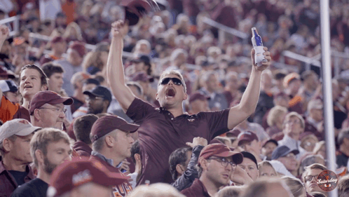 Man in Maroon Shirt Holding Budweiser