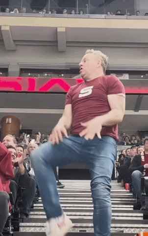 Man in Maroon Shirt With Letter S Dancing
