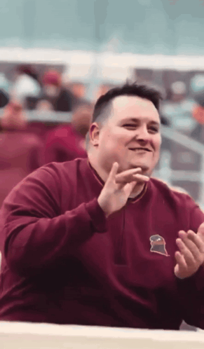 Man in Maroon Sweatshirt With Gator