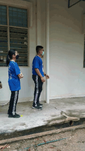 Man In Mask And Girl In Blue Shirt Saying A GIF