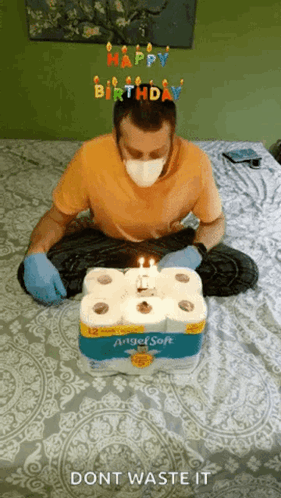 Man in Mask and Gloves With Toilet Paper Cake