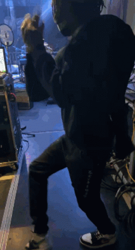Man In Mask And Headphones Standing On One Leg GIF