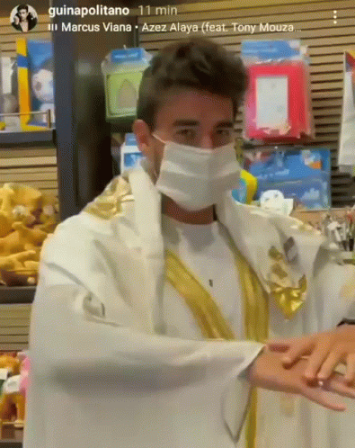 Man in Mask and Robe Standing in Store