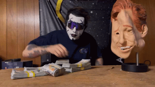 Man in Mask and Sunglasses Next to Money