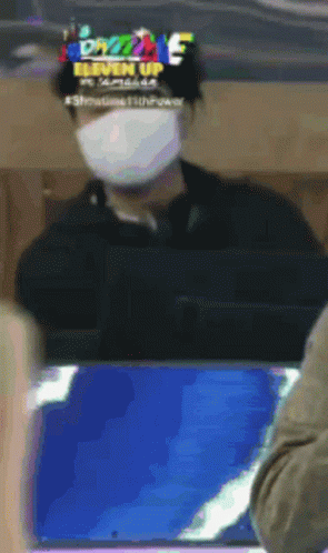 Man in Mask at Computer Saying Eleven Up