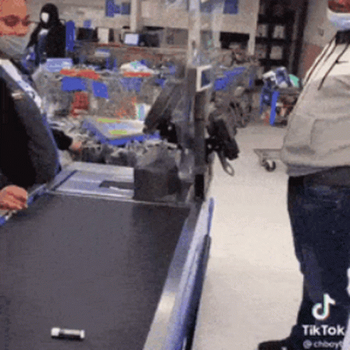 Man in Mask at Grocery Store Cash Register