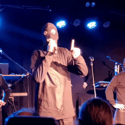 Man in Mask at Microphone