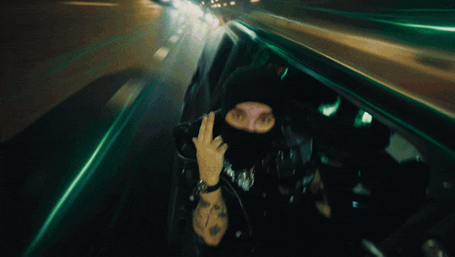 Man in Mask Giving Middle Finger Blurry Photo