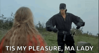 Man in Mask Holding Sword Next to Woman in Field