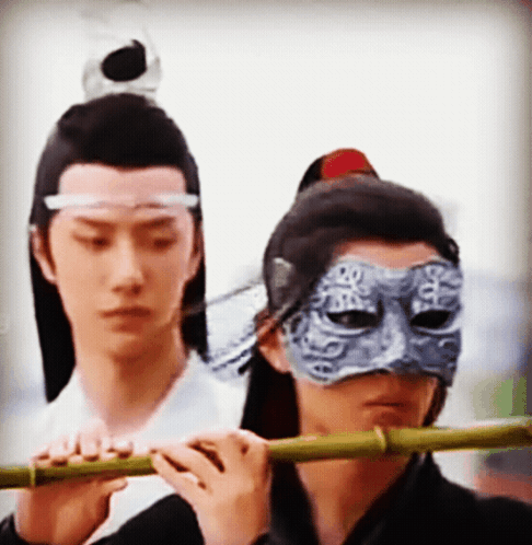 Man In Mask Playing Flute GIF