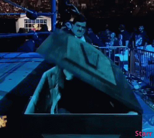 Man In Mask Sitting In Coffin With Word Starr GIF