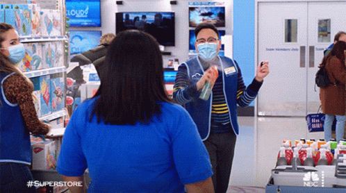 Man In Mask Spraying Woman In Store GIF