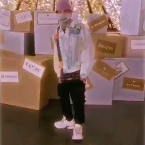 Man in Mask Standing in Front of Boxes