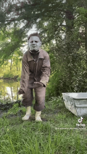 Man in Mask Standing Near Lake
