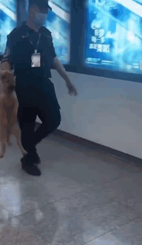 Man in Mask Walking Dog in Hallway