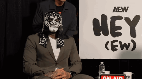 Man In Mask With Sign Hey (Ew)