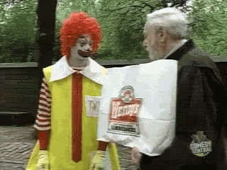 Man in McDonald's Costume Holding Wendy's Hamburgers