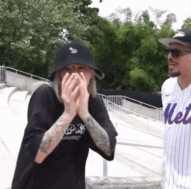 Man in Mets Jersey and Woman Covering Face