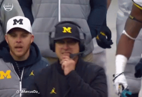 Man in Michigan Hat and Headphones Talking