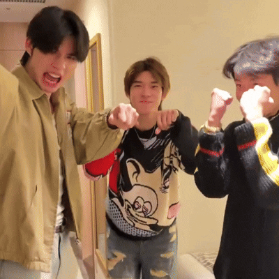 Man in Mickey Mouse Sweater Pointing