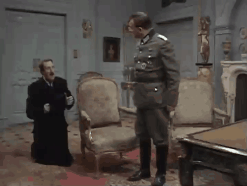 Man in Military Talking to Man in Black Robe