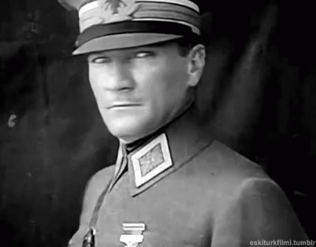 Man in Military Uniform and Hat Looking at Camera