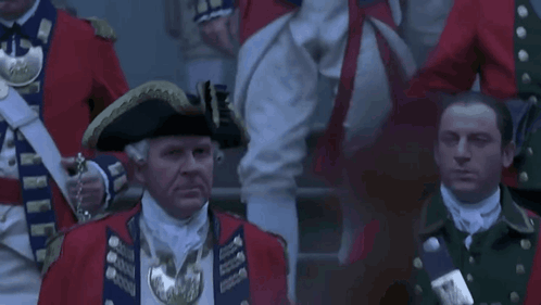 Man in Military Uniform and Hat With Flag Saying Nearly
