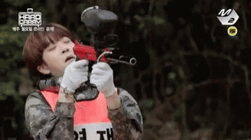 Man in Military Uniform Holding Paintball Gun