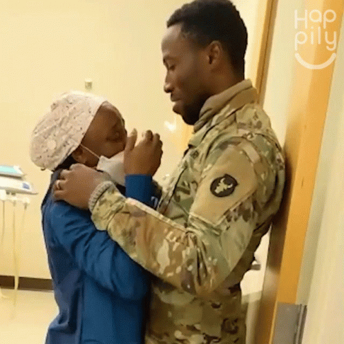 Man in Military Uniform Hugging Nurse