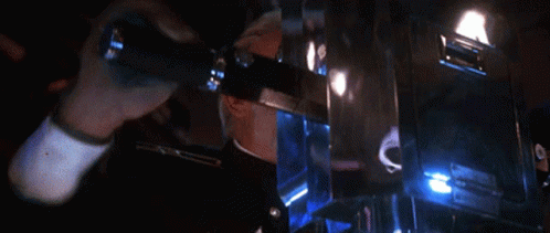 Man In Military Uniform In Dark Room With Blue Lights GIF