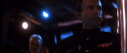 Man In Military Uniform Looking In Dark Room GIF
