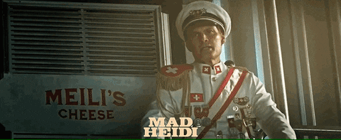 Man in Military Uniform Standing in Front of Meili's Cheese Sign