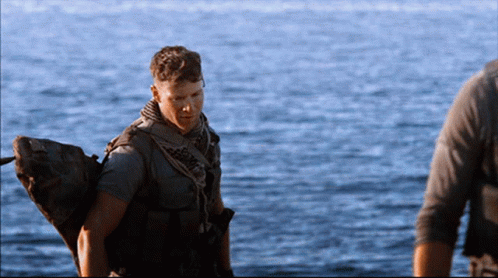 Man in Military Uniform Standing in Water