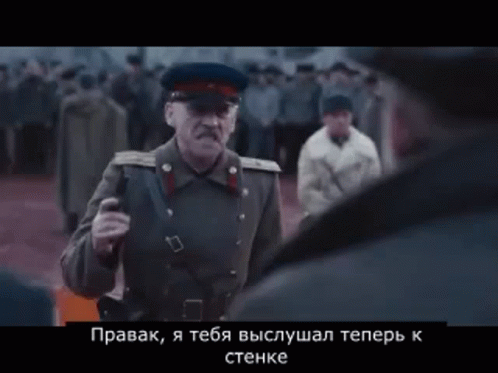 Man in Military Uniform Talking to Another in Crowd