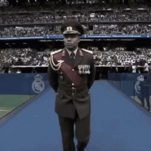 Man in Military Uniform Walking on Blue Carpet