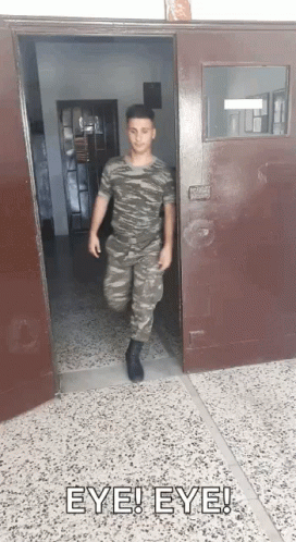 Man in Military Uniform Walking Out Door With Eye Eye Above
