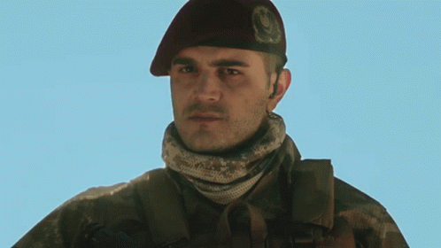 Man in Military Uniform With Beret Letter O