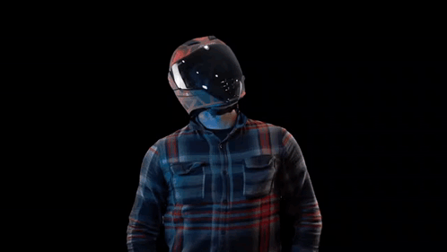 Man in Motorcycle Helmet and Plaid Shirt Raising Arms
