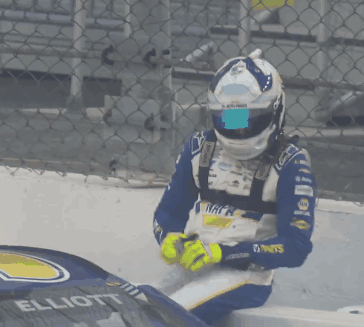 Man in Napa Helmet Sitting on Race Car