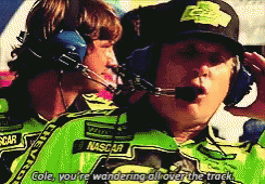 Man in NASCAR Shirt Talking to Man in Headphones