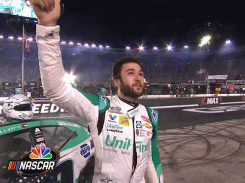 Man in NASCAR Uniform Holding Up Hand