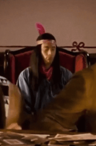 Man in Native American Costume at Desk